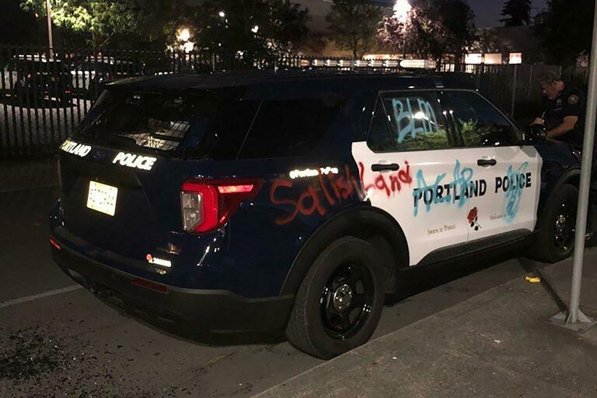 Portland police declare riot as anti-cop protesters torch union building