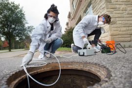 University of Guelph engineering students Melissa Novacefski, left, and Jonathan Evans, pump wastewater from a sewer outside a student residence on campus in late September to test for traces of COVID-19 RNA. Similar studies are being conducted in other cities, including Toronto.