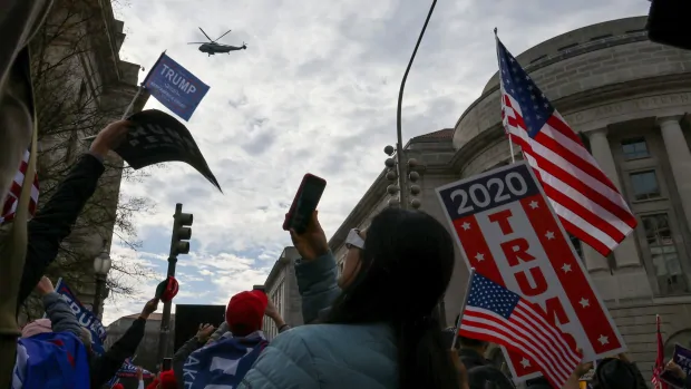 Trump helicopter passes over supporters rallying in Washington against election results