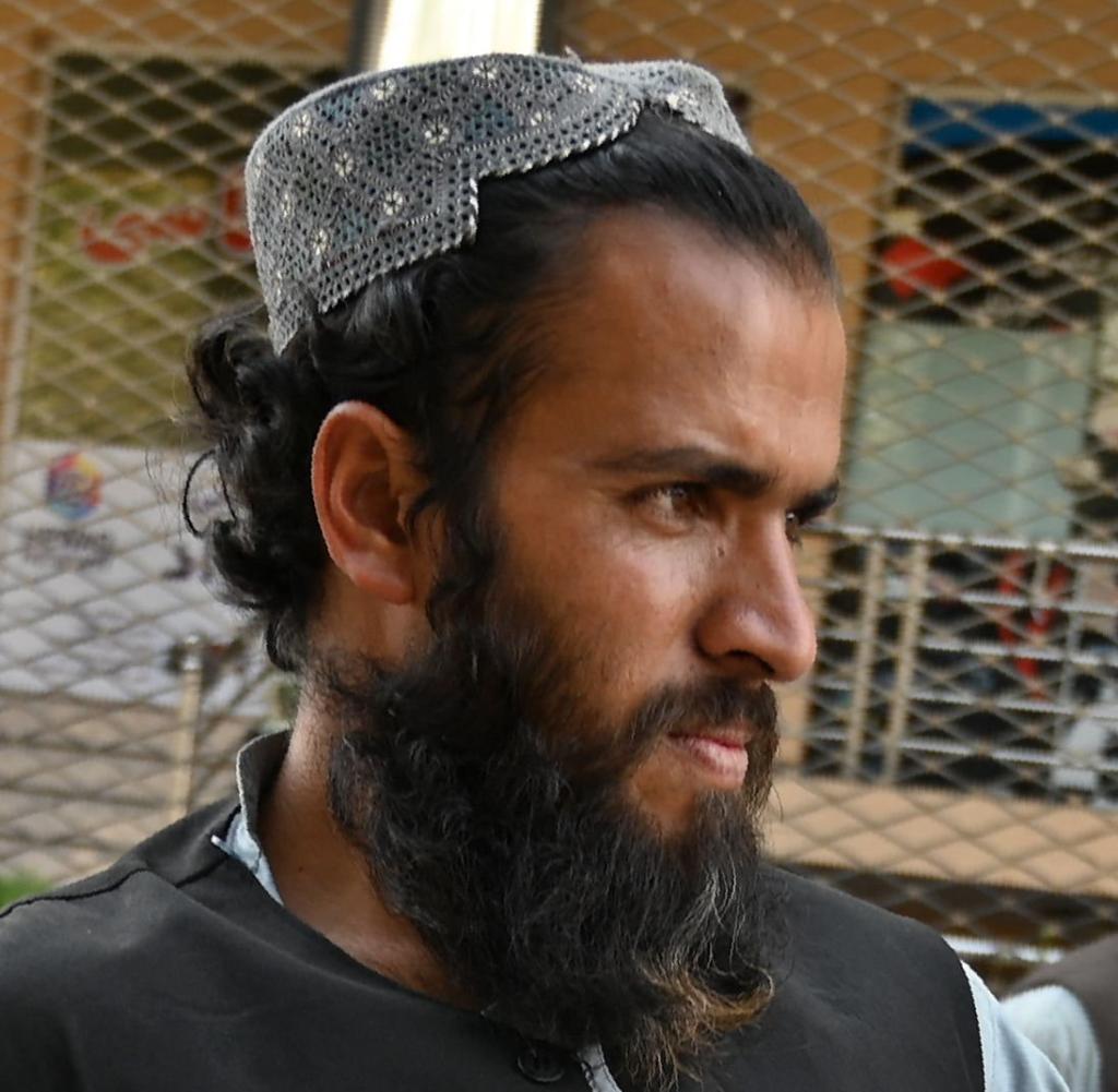 In early October, a Taliban fighter guarded a passage in Kabul in front of an office responsible for issuing passports