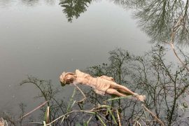 The body of Christ from the cross of the fire station in Mellon lies in the pond in the adjoining village.  Arms are torn.