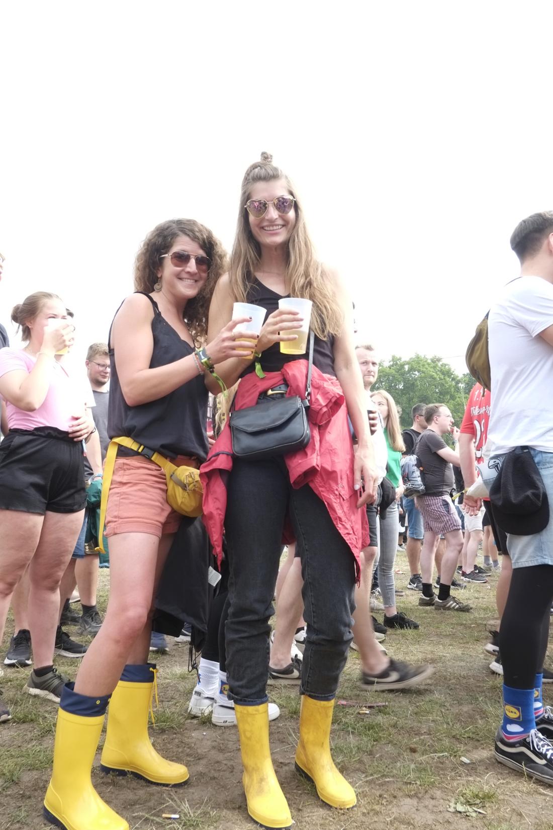 Yellow rubber boots as a fashion statement in the sun at the Rock im Park Festival 2022 in Nuremberg.