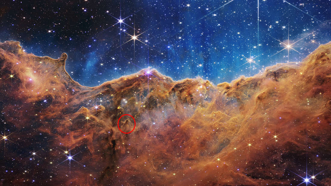 Astronomers marvel at the tubular structures in the Carina Nebula (marked in red).  What picture did the James Webb telescope capture here?