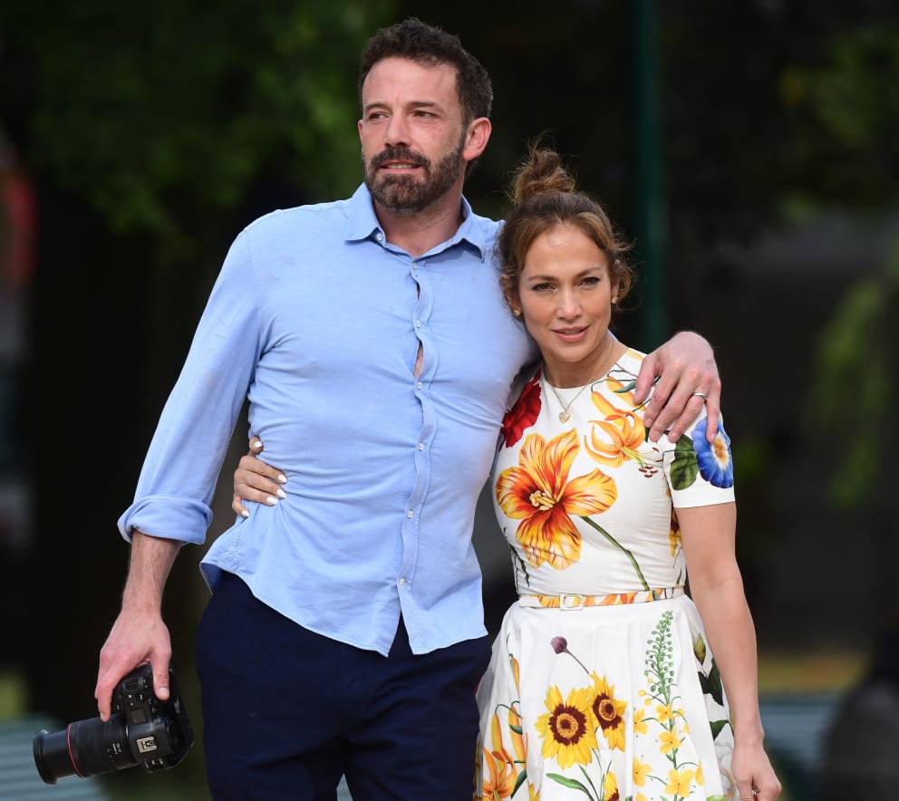 This is what happiness looks like: Jennifer smiles in husband Ben Affleck's arms, takes his last name