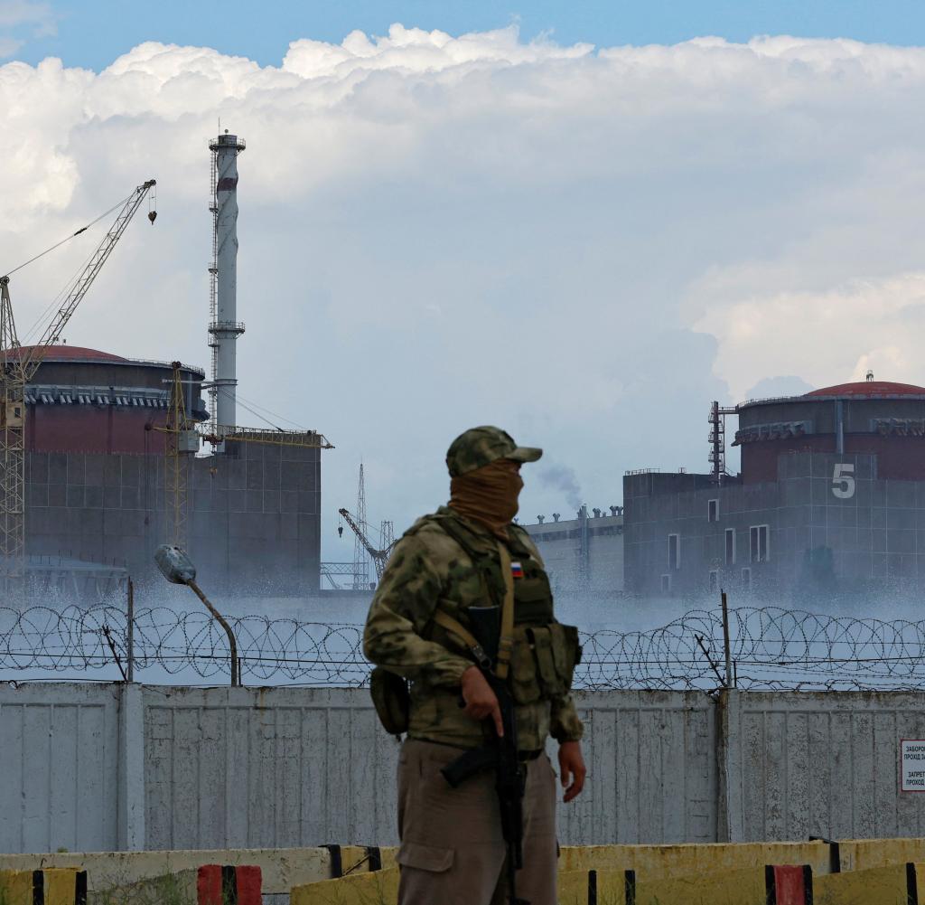 Zaporizhia.  A Russian soldier standing in front of a nuclear power plant in