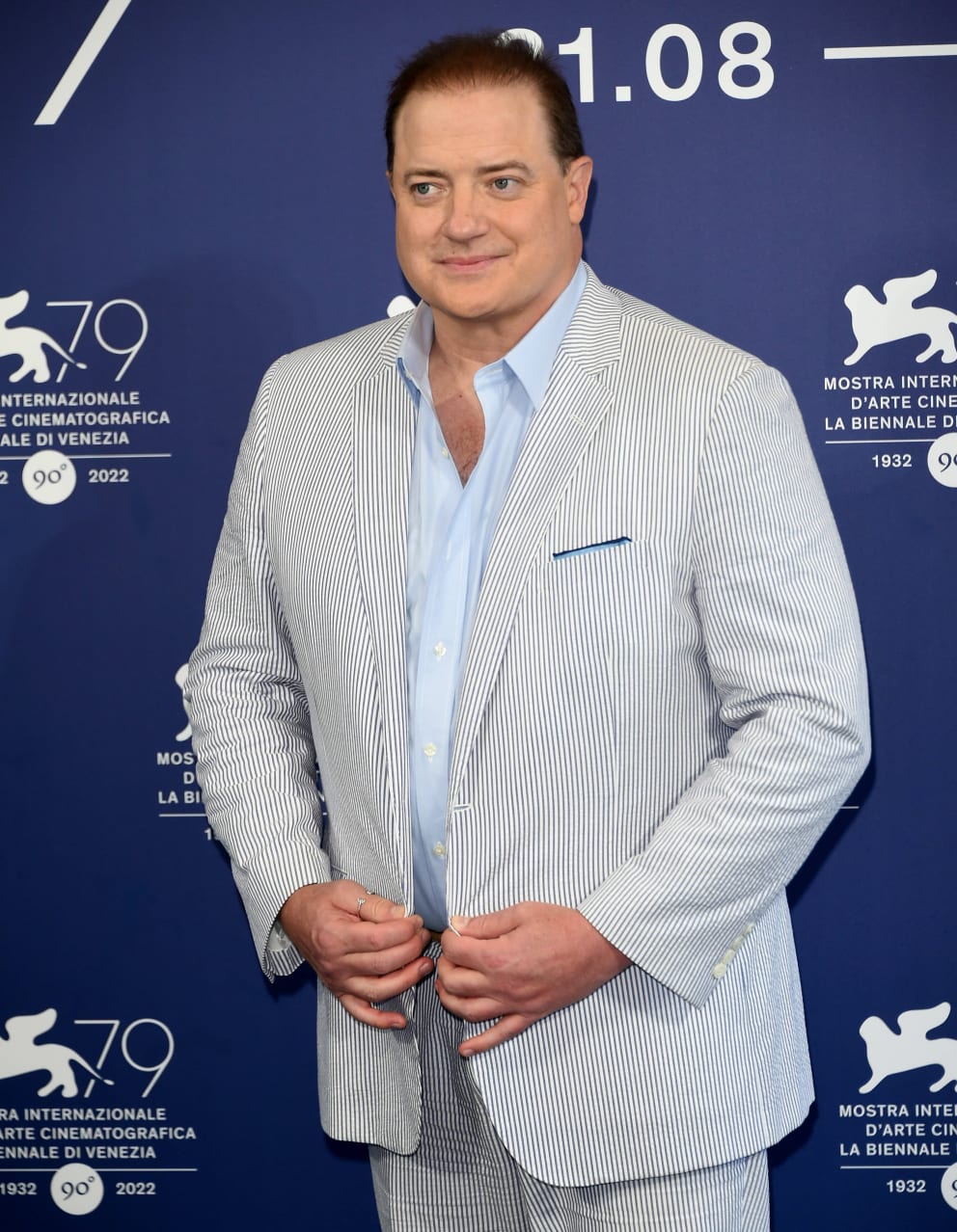 Attention, Camera!  Brendan Fraser quickly sucks his belly, clutching his striped jacket with a restrained smile