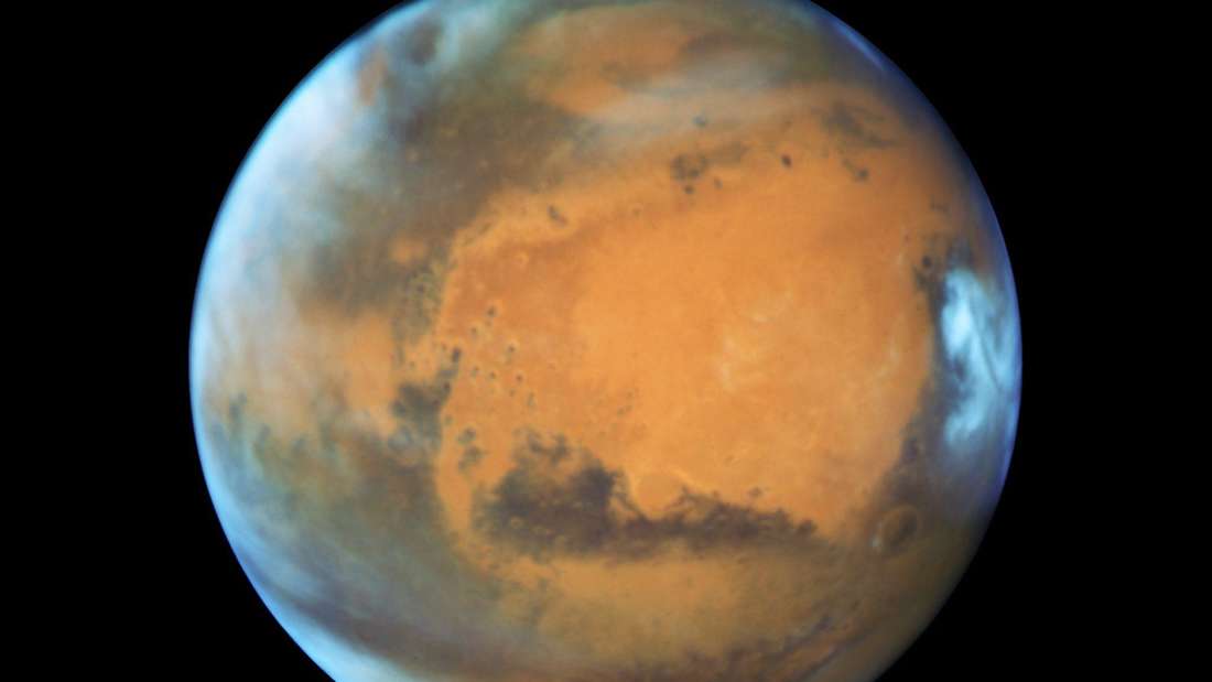 Mars is the planet most explored by human instruments.  There are many orbiters orbiting the Red Planet and many rovers and other research instruments are also active on its surface.